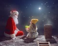 Girl and Santa Claus sitting on the roof