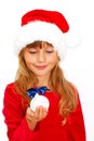 girl in santa cloth with christmas ball in hand