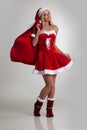 Girl in santa dress with gift bag Royalty Free Stock Photo