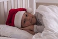 Girl in santa hat on the bed