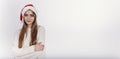 The girl in santa hat looking at camera and smiling. Royalty Free Stock Photo