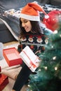 Girl with Santa hat looking at opened empty present Royalty Free Stock Photo