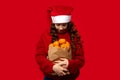 Girl in Santa hat looks down at bag with oranges Royalty Free Stock Photo