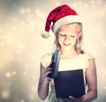 Girl with Santa Hat Opening Gift Box Royalty Free Stock Photo