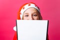 Girl in Santa hat and tinsel on the neck, a teenager holding a t Royalty Free Stock Photo