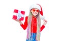 Girl in Santa`s hat. Portrait of little cute girl holding box of Christmas present, Small girl hug her gift with happy Royalty Free Stock Photo