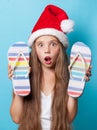 Girl in Santas hat with flip flops