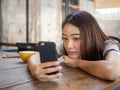 The girl sat staring at the phone in hand. A sad expression awaits the boyfriend calling Royalty Free Stock Photo