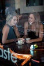 Girl sat in the window of a coffee shop