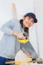 Girl sawing wooden beam hand saw Royalty Free Stock Photo