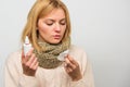 Girl in scarf hold nasal spray and tissue. Cold and flu remedies. Runny nose and other symptoms of cold. Nasal drops Royalty Free Stock Photo