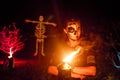 Girl with scary face paint make up during Halloween party at the artificial cemetery on the beach