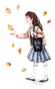 A girl in a school uniform catches autumn leaves for a walk Royalty Free Stock Photo