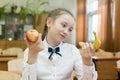 Girl in school uniform chooses food for lunch Royalty Free Stock Photo