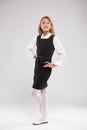A girl in a school uniform coquettishly poses for the camera Royalty Free Stock Photo