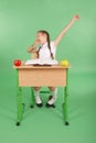 Girl in a school uniform sitting at a desk and yawns