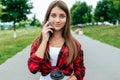 Girl schoolgirl teenager 10-15 years old, summer city after school lessons. In hands of smartphone, calling by phone Royalty Free Stock Photo