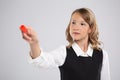 Girl schoolgirl writes on the Board with red chalk Royalty Free Stock Photo