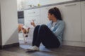 Girl scolding her dog in the kitchen Royalty Free Stock Photo