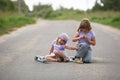 Girl scooter fell In the countryside, sister helps her child Royalty Free Stock Photo