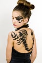 Girl with scorpio painted on back