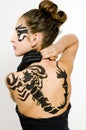 Girl with scorpio painted on back