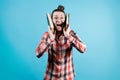 The girl screams joyfully, clutching large books to her head with her hands Royalty Free Stock Photo