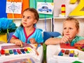 Girl sculpt of plasticine on desk in Royalty Free Stock Photo