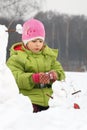 Girl sculpt from snow much snowman