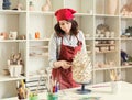 Girl sculptor in the workshop sculpts from clay