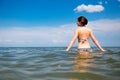 Girl in the sea on blue sky