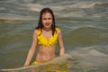 Girl at sea. Teenager summer vacation sand. Sunny day and the sea. travel vacation. Teenager in a yellow swimsuit Royalty Free Stock Photo