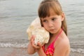 Girl with sea shell at the beach Royalty Free Stock Photo