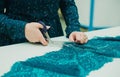 Girl seamstress working in his Studio. Female hands holding a pair of scissors Royalty Free Stock Photo