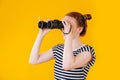 Girl in search with binoculars in hand Royalty Free Stock Photo
