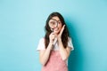 Girl searching for you. Cute smiling woman recruiter look through magnifying glass, staring at camera, investigating Royalty Free Stock Photo