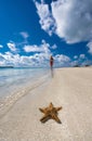 Girl on seashore and starfish Royalty Free Stock Photo