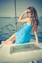 Girl seating on a yacht on summer day