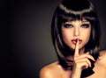 The girl with a secret . Model brunette with hairstyle of the care. Royalty Free Stock Photo