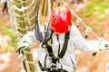 Girl seen from above climbing in high rope course