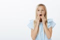 Girl sees adorable doll in store, asking mother to buy it. Portrait of amazed and surprised cute fair-haired daughter Royalty Free Stock Photo