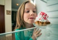 Girl sees the sweet cake Royalty Free Stock Photo
