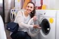 Girl selecting new washing machine Royalty Free Stock Photo