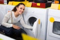 Girl selecting new washing machine Royalty Free Stock Photo