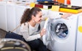 Girl selecting new washing machine Royalty Free Stock Photo