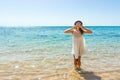 Girl sends an air kiss to the camera. a beautiful carefree Woman relaxing at the beach enjoying her sun white dress Royalty Free Stock Photo