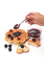 Girl served waffles with blueberry jam, Breakfast with coffee