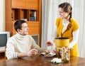 Girl serving soup her man Royalty Free Stock Photo