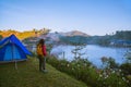 The girl set up a camp on the mountain near the lake, Camping Travel Concept, natural rhythms, fog in the winter Royalty Free Stock Photo