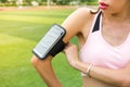 Girl setting up smartphone to track jogging activity